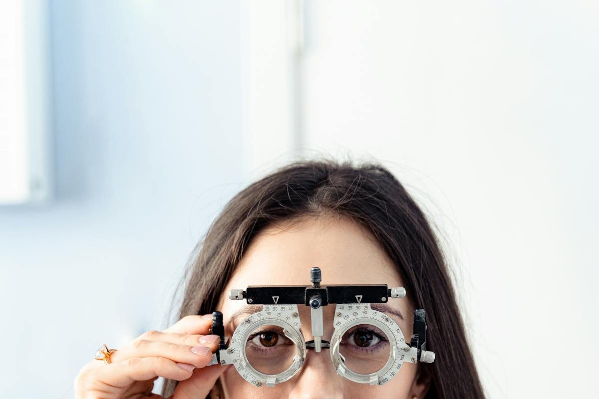 Woman wearing eye trial frame during prescription check